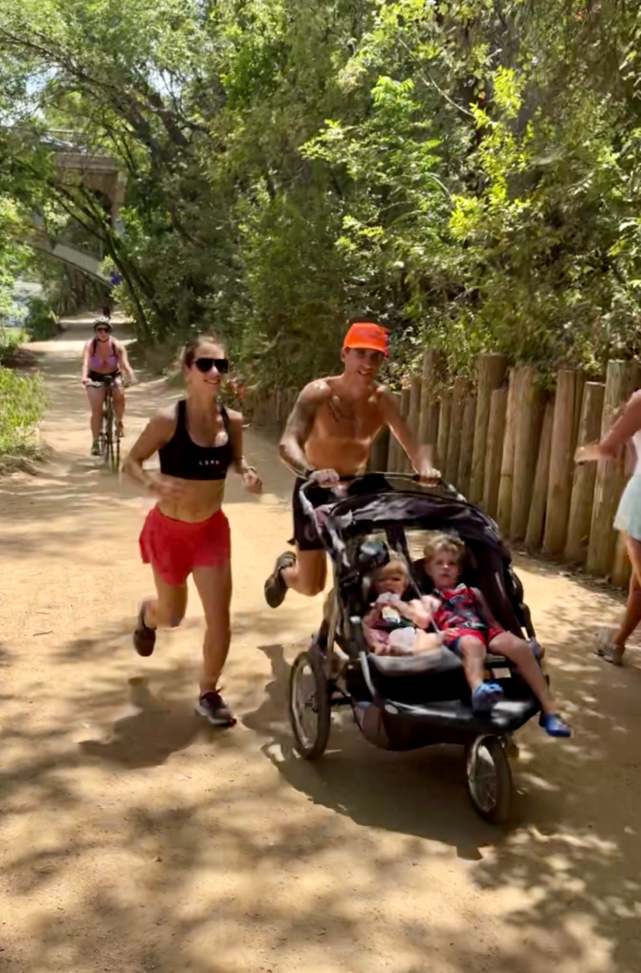 CJ Finley running a trail with his family in a jogging stroller